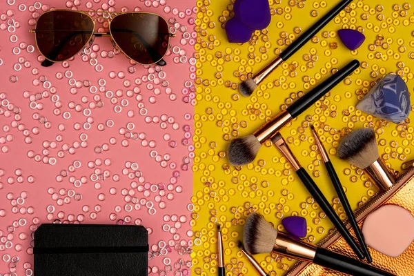 Makeup accessories with brown sunglasses, flat lay