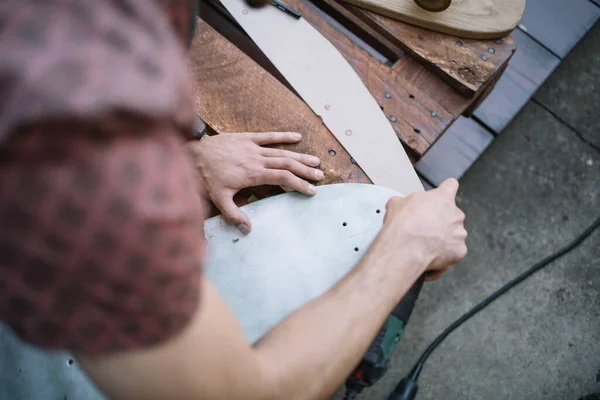 Top view of male hands polishing wooden board — Stock Photo, Image