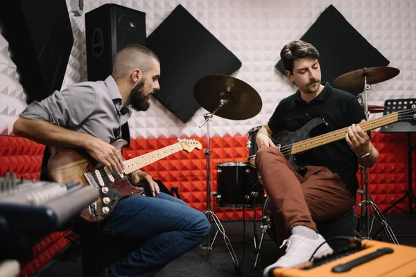 Kytaristé nacvičují, zatímco sedí v nahrávacím studiu — Stock fotografie