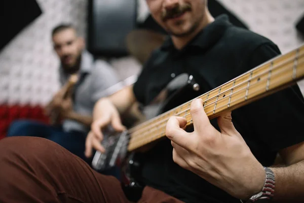 Blurred male guitarists playing guitars in studio — Stock Photo, Image