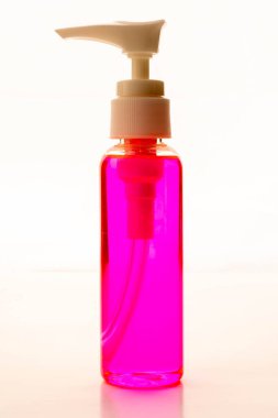 Beyaz arkaplanda izole edilmiş pembe el dezenfektanının yakın görüntüsü