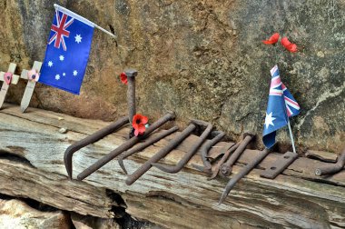 HELL FIRE PASS MEMORIAL IN THAILAND, TOOLS USED FOR DIGGING THE ROCK WITH AUSTRALIAN FLAGS clipart