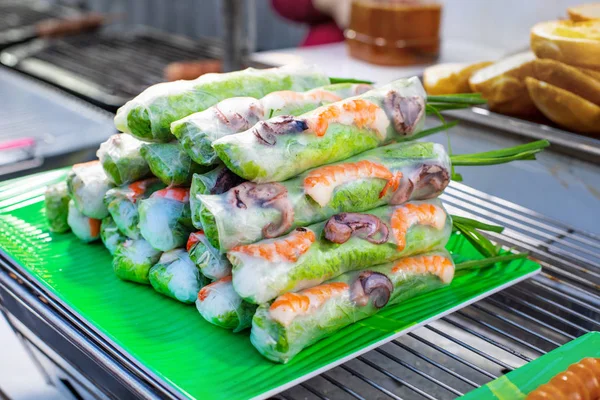 Street market with Vietnamese food and cousine. Spring rolls with seafoods and vegetables.