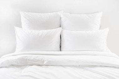 White bed isolated, four white pillows and duvet on a bed clipart
