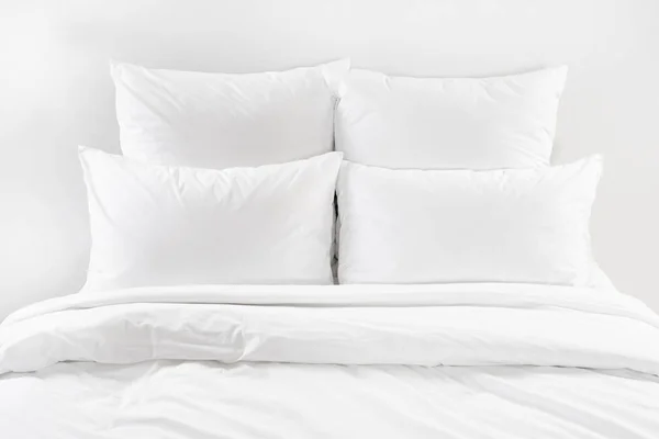 White bed isolated, four white pillows and duvet on a bed — Stock Photo, Image