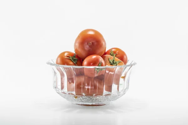 Tomatoes in crystal bowls. White background. It was taken in the studio.