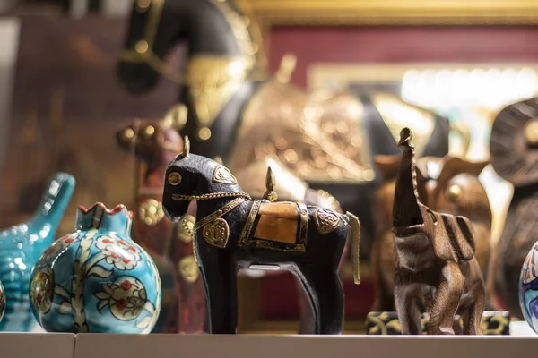 Close-up of poppy horse in souvenir store. Porcelain box on the left. Wooden elephant on the right. — 图库照片