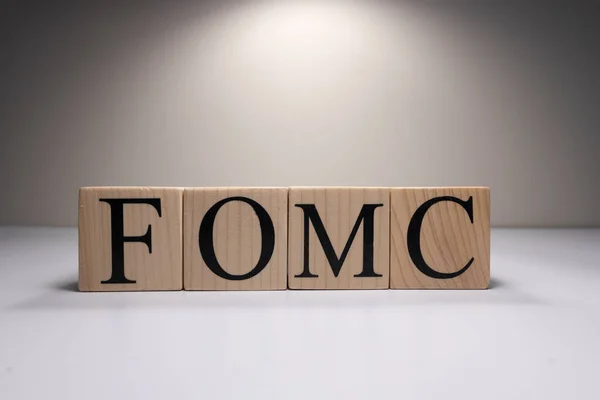 FOMC Meeting Minutes word over Candlestick chart Forex background.