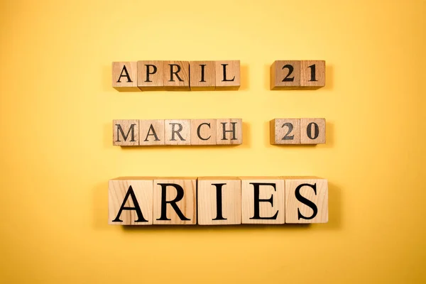 Aries word on wooden cubes on white background. Photographed in the studio and in spot light. Zodiac or star signs consists of 12 horoscopes.