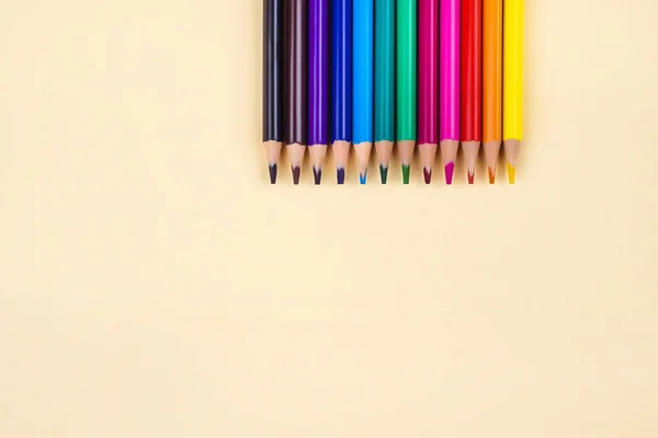stock image Colored pencils on yellow background.