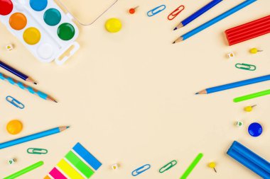 Sarı arka planda okul aksesuarları. Pastel renkli.