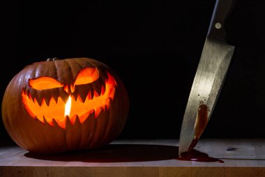 Masasında bıçak olan turuncu balkabağı.