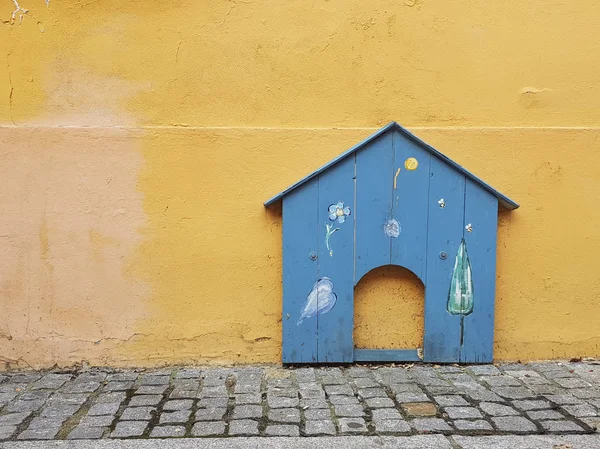 Wood shaped dog house entrance