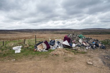 household rubbish discarded on a remote moorland location clipart