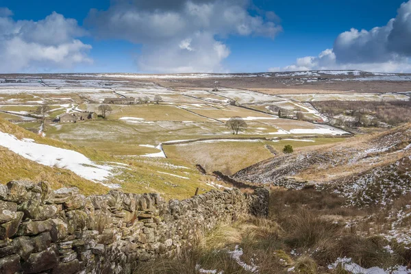 winding dry stone wall in a west yorkshire winter landscape