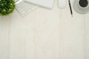 Dizüstü bilgisayarı, akıllı telefonu ve malzemeleri olan ahşap çalışma masası..