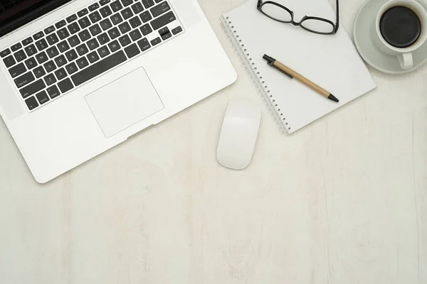 top view of wooden table top with computer laptop , notepad, coffee 2