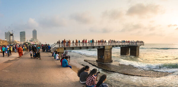 COLOMBO, SRI LANKA - February  19, 2019: Panoramic view of the Galleface Observation Deck full of people and the local street food market in Colombo, Sri Lanka.