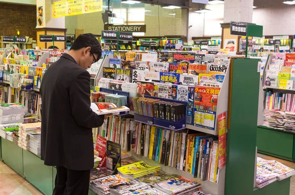 Japanese girl reading a comic book.