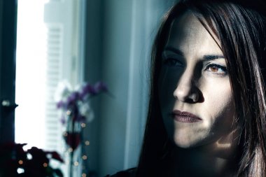 Bir kadının portresi üzgün ve düşünme, düşük anahtar, kapalı.