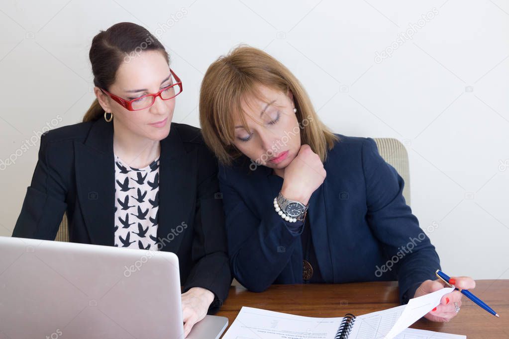 Two business women working at home office.