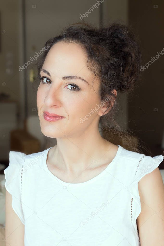 Portrait woman 31 years old, updo hair.