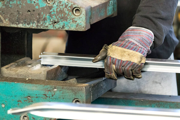 A man machine operator using safety gloves to make stretching.