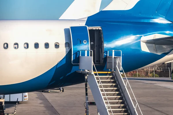 Close-up of rear door open and a passenger airstairs of a jet ai