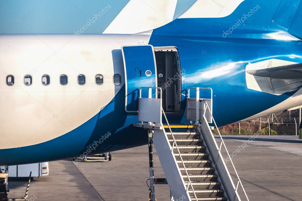 Close-up of rear door open and a passenger airstairs of a jet ai