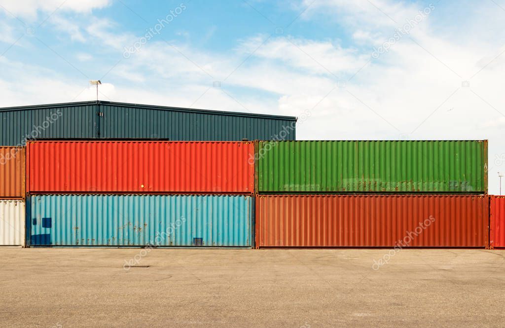 Shipping containers stacked outdoors.