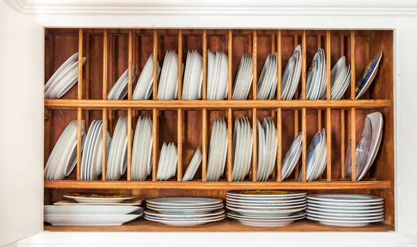Wooden plate rack inside a vintage cupboard. — Stock Photo, Image