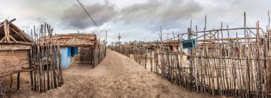 Andavadoaka, Madagaskar'da kum ve ahşap çitlerle dolu bir caddenin görünümü.