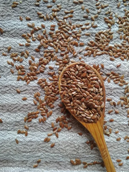 Flax seeds, linen, spoon with flax seeds