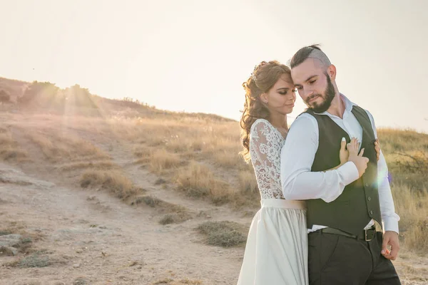 愛の新郎新婦、山の近くの結婚式の日の若いカップル。幸せと愛の瞬間をお楽しみください。豪華なウェディングドレスの花嫁 — ストック写真