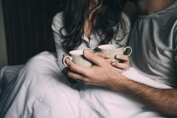 Lovers holding together a Cup of tea — Stock Photo, Image