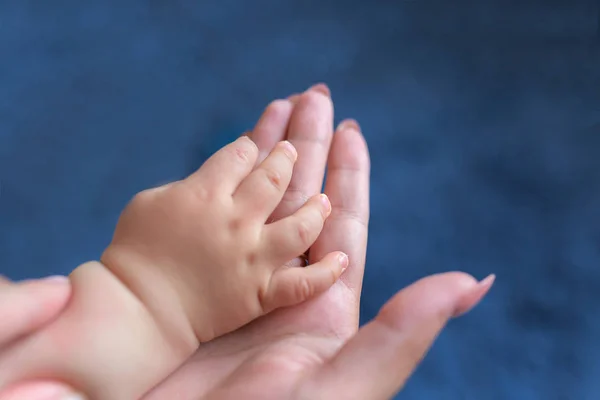 Pés de bebé nas mãos da mãe. Pequenos pés de bebê recém-nascido em mulheres em forma de mãos closeup. A mãe e o filho. Conceito de família feliz. Bela imagem conceitual da maternidade — Fotografia de Stock