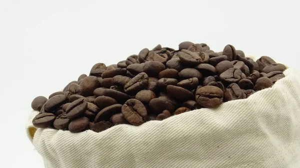 A sack with roasted coffee beans on white background — Stock Photo, Image