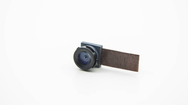Close up on a camera module for mobile phone. Closeup of Smartphone Lens in studio picture with white background