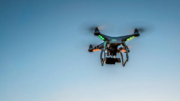 View of drone flying with digital camera and blue sky background