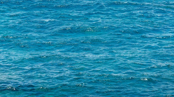 Natural blue sea surface. Ocean water background. Coastline of tropical beach