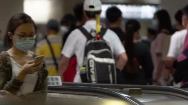 Taipei, Tayvan-07 Haziran 2020: Yerel halkın bulaşıcı hastalıklara karşı koruyucu maske takması ve toplu taşımacılığın yürüyen merdivenlerindeki gribi koruması. Coronavirus-Dan