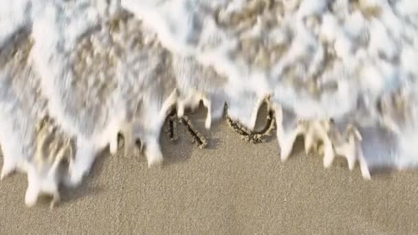 Rallentamento Del Virus Scritto Sulla Sabbia Della Spiaggia Con Lavaggio — Video Stock