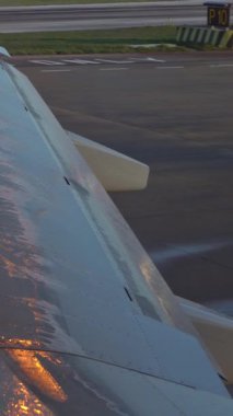4K, Close-up an wing of aircraft moving to check and getting the plane ready for departure at international aiport. Jet wing after an anti-icing treatment.