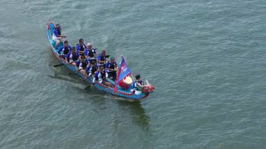 Taipei, Taiwan-08 June, 2024: Slow motion of Taipei paddlers racing together, filmed from shore with intense paddling and synchronized effort under strong sunlight.