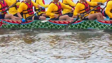 Taipei, Taiwan-08 June, 2024: Slow motion of Taipei paddler stretching gently with paddle behind head, glowing water and warm sky reflections.