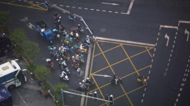 Chengdu, China-11 October, 2024: Elevated view of vehicles moving through urban intersection with yellow box markings and road signs in Chengdu