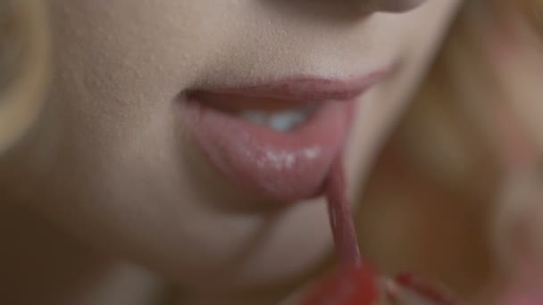 化粧をしている美しい女の子 着色された背景にアプリケーターでマットな口紅を塗る若い女性 化粧品や美しさの概念 — ストック動画
