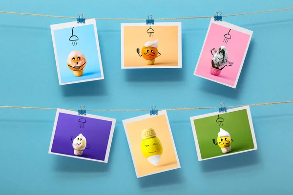 pictures with funny washing fruits hanging on a linen thread on stationery clips on a colored background, concept of cheerful mood, design of a children's wall decor, advertising of food business
