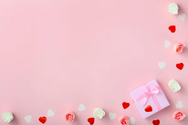Gifts with confetti hearts and roses, boxes wrapped in decorative paper on pastel colored pink background, top view, holiday concept — Stock Photo, Image