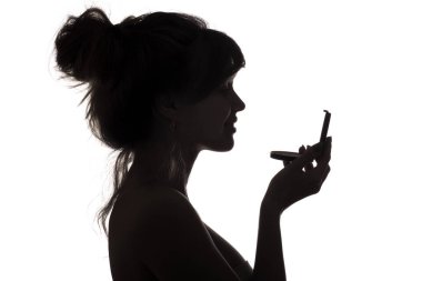 silhouette of woman admiring herself in a mirror, profile of a woman face, concept of fashion and beauty clipart